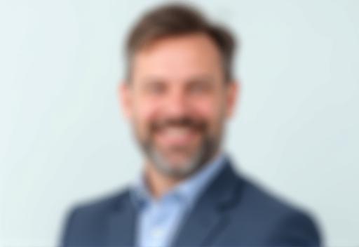 Professional and approachable corporate headshot of a man